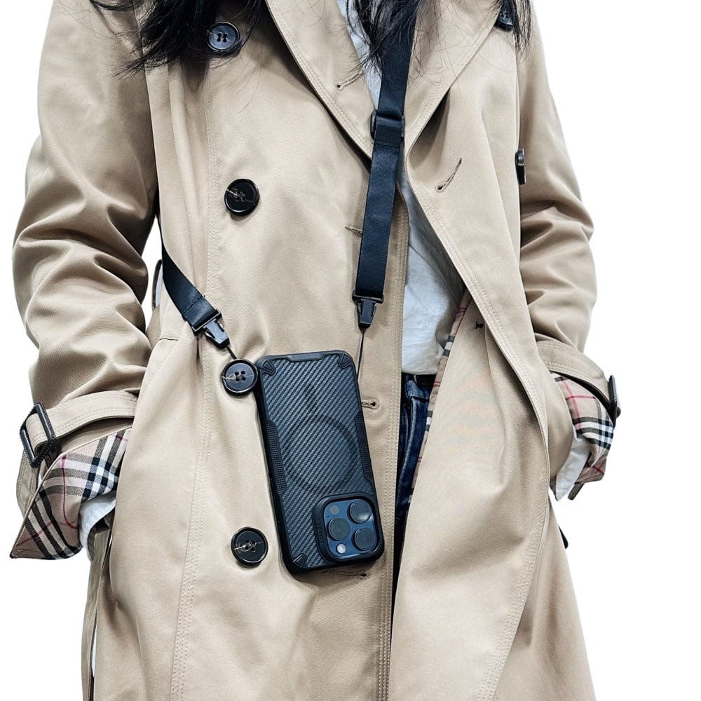 A person wearing a beige trench coat with an iPhone 16 Pro Max encased in a Lightweight MagSafe case made of TPU+PC material, featuring a shockproof air cushion and impact-resistant design, attached to a black strap hanging around their neck.