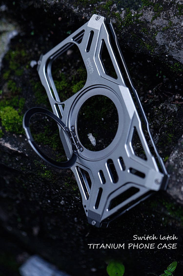 An iPhone 16 Pro Max Aerospace Aluminum MagSafe Case, featuring a switch latch and 360° ring kickstand for shockproof protection, is displayed outdoors on a moss-covered surface.