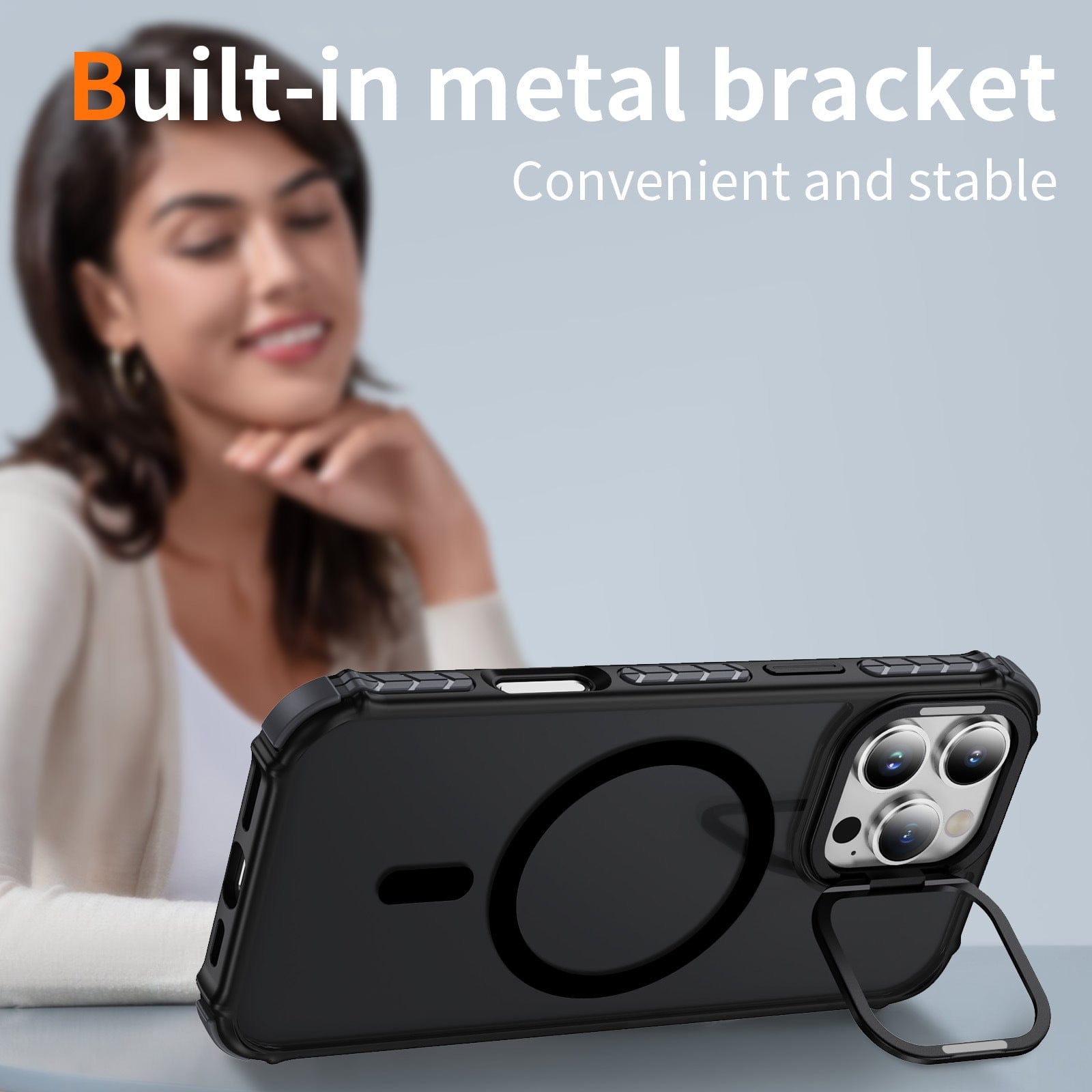 A person sits in the background while an iPhone 16 Pro Max Rugged MagSafe Case with a metal kickstand and orange accents is prominently featured in the foreground. Text reads "Metal kickstand - Convenient and stable.