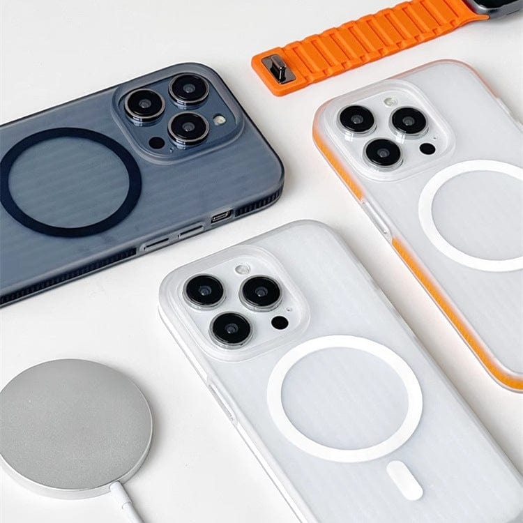 Three iPhone 16 Pro Max units encased in Corrugated Matte Texture, MagSafe Compatible, Shockproof Slim Design cases, a smartwatch with an orange strap, and a circular wireless charger are arranged on a white surface.