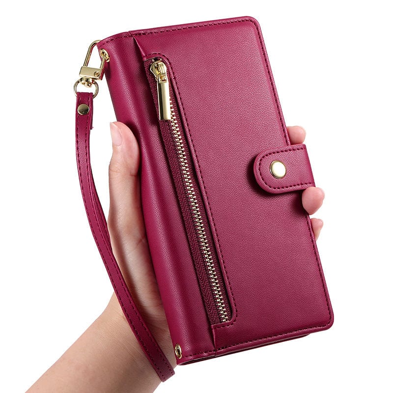 A hand holding the iPhone 16 Pro Max Wallet Case made from premium leather, featuring a zippered pocket, card holder, stand function, snap button closure, and gold hardware.