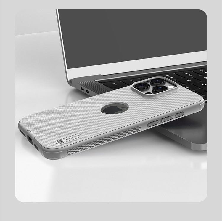 A silver smartphone in an iPhone 16 Pro Max Protective Case with textured grip, anti-drop features, and precise cutouts lies on a laptop keyboard, screen facing down and camera lenses visible.