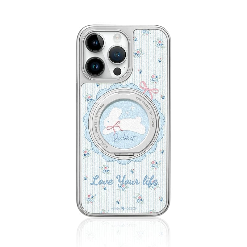 A charming smartphone case for your iPhone 16 Pro Max, featuring an elegant chrome-plated stand with SGS-certified drop protection, adorned with a delightful blue floral rabbit design, playful blue bows, and a striped backdrop showcasing the uplifting "Love Your Life" message.