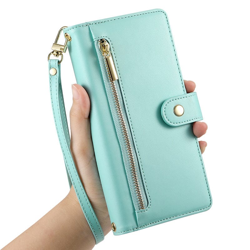 A hand holding a premium leather light blue iPhone 16 Pro Max wallet case with a wrist strap, zipper pocket, and button snap closure.