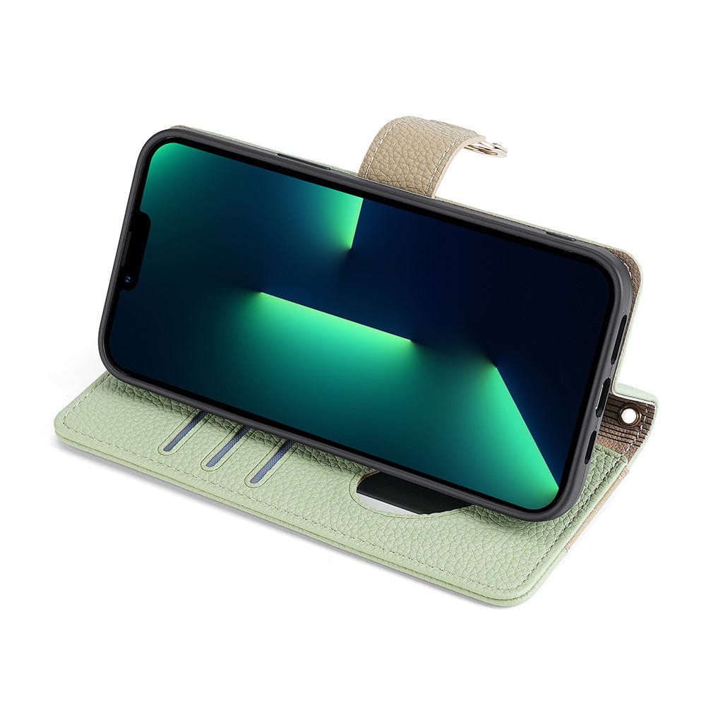 An iPhone 16 Pro Max is held horizontally in a light green crossbody wallet case, featuring PU leather with a built-in mirror and card slots inside. The screen displays a geometric green and black pattern, and the case includes a hidden stand for support.