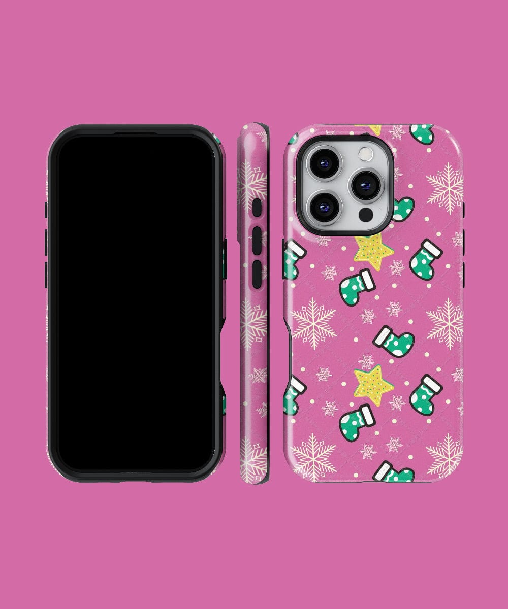 The Festive Stocking iPhone 16 Pro Max Case features a pink holiday design adorned with snowflakes, green mittens, and yellow stars. It is MagSafe compatible and displayed from three angles.