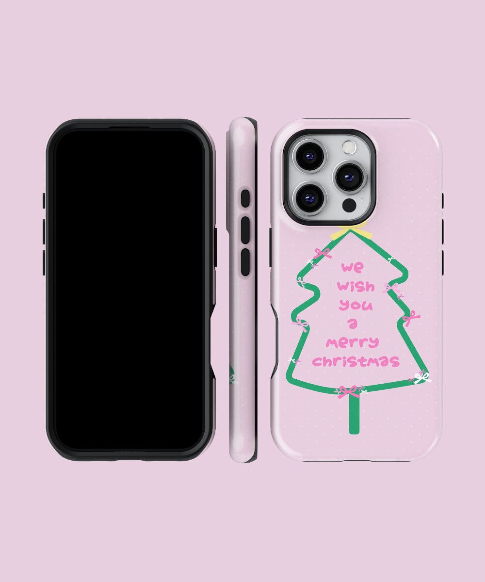 The Merry Christmas Tree iPhone 16 Pro Max Case – featuring a festive pink and green design with holiday cheer, is MagSafe compatible and showcases a Christmas tree and "We wish you a Merry Christmas" text. Displayed from front, side, and back views against a pink background, this dual-layer protection case offers robust safety while celebrating the holiday spirit.