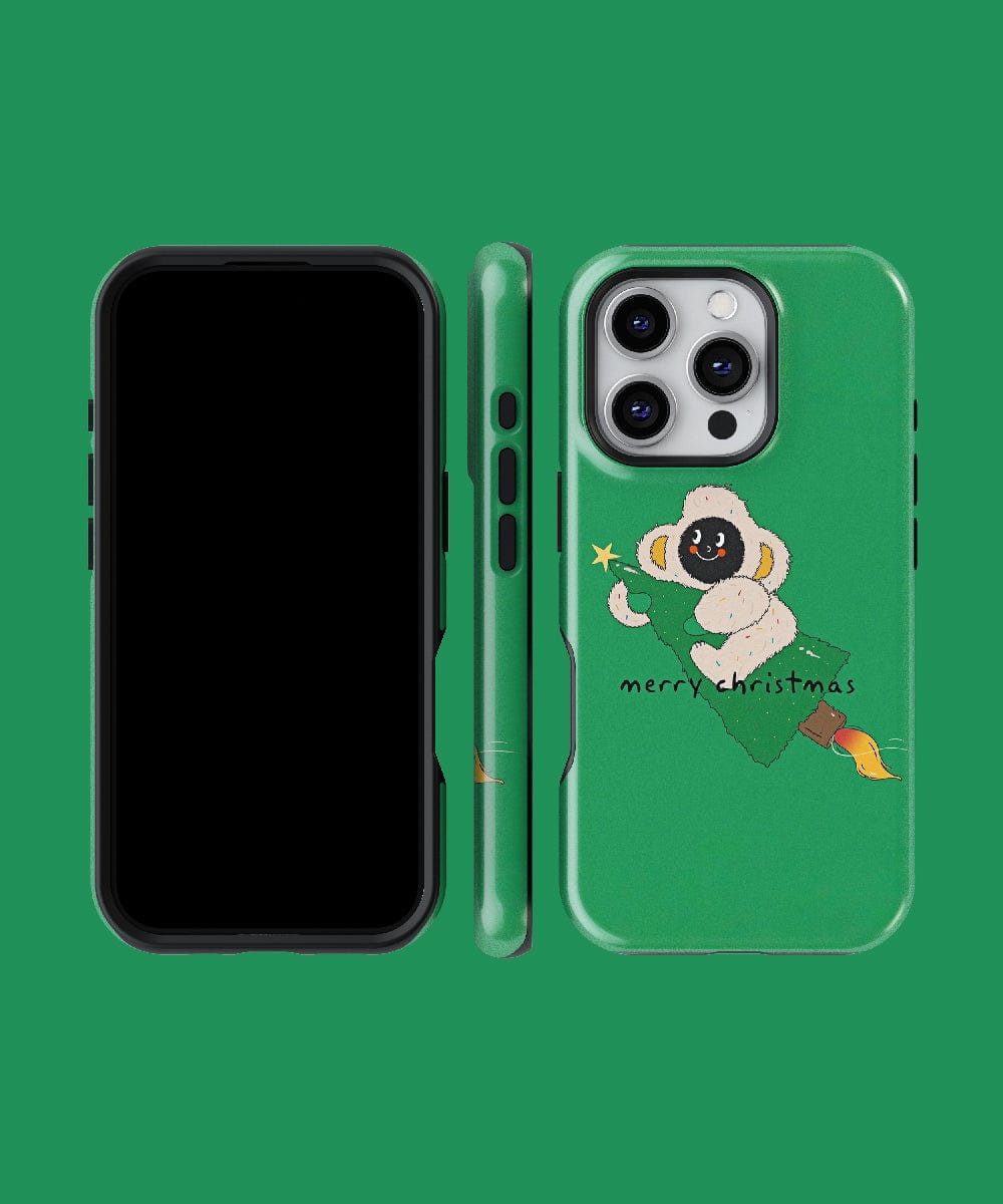 Green phone case with a festive monkey holding a star, designed for the iPhone 16 Pro Max and featuring MagSafe compatibility. Text reads "Merry Christmas." The case is shown from back, side, and front.