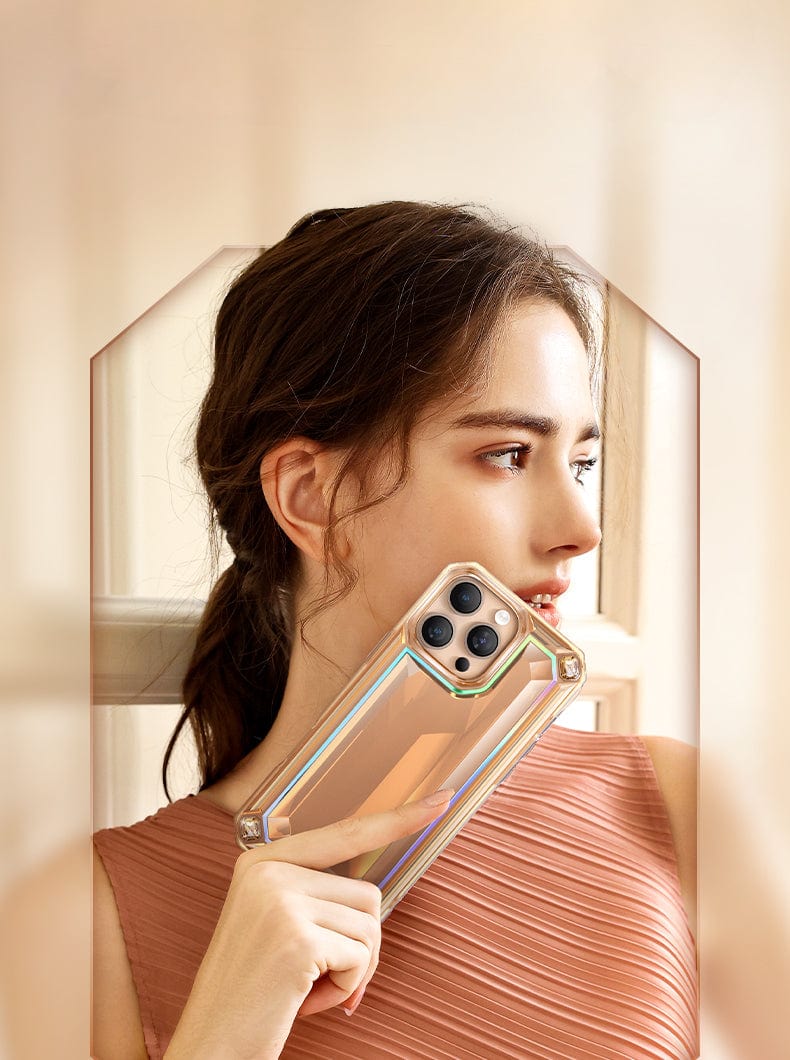 A woman with long hair in a ponytail holds an iPhone 16 Pro Max Case - Shockproof 360° Clear Anti-Fall Protective Cover with 3D Gem Design near her face. She is wearing a sleeveless, pleated dress and looking to the right.