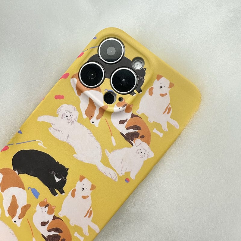 The Playful Pups iPhone 16 Pro Max Case - Cute Dog Pattern Design with Full Protection is a yellow case adorned with cartoon illustrations of various dog breeds, including a black dog, a white fluffy dog, and brown and white spotted dogs. It features multiple cutouts for the phone's camera lenses and has a light, fuzzy background surface.