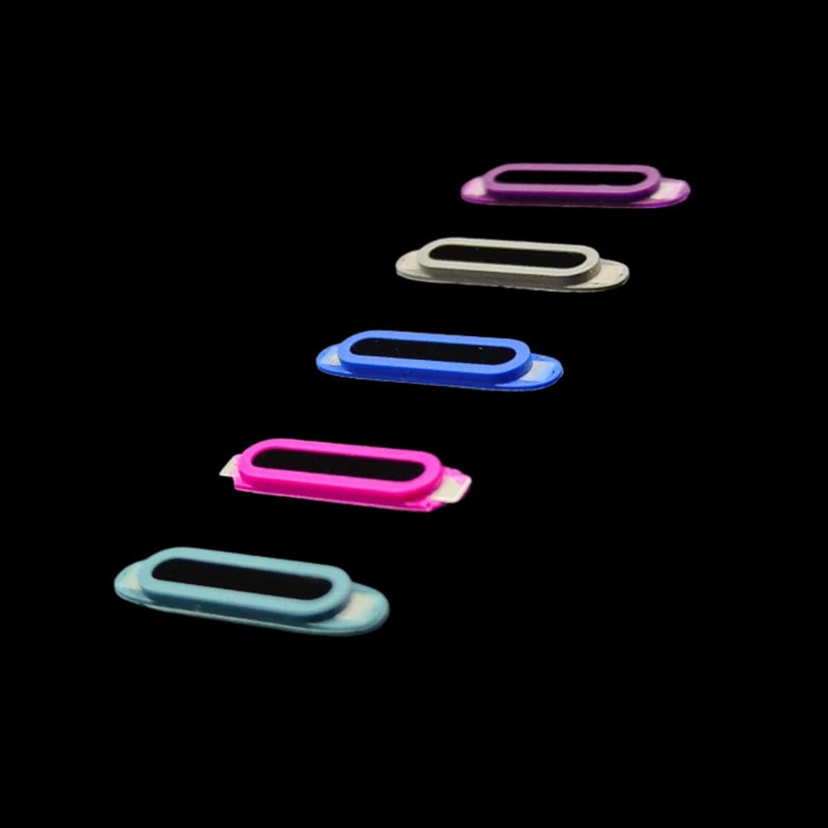 Five vibrantly colored oval magnets arranged in a diagonal line on a black background, as if waiting for the Capture Button for iPhone 16 Pro Max Cases – Enhanced Camera Control Attachment to immortalize their allure.