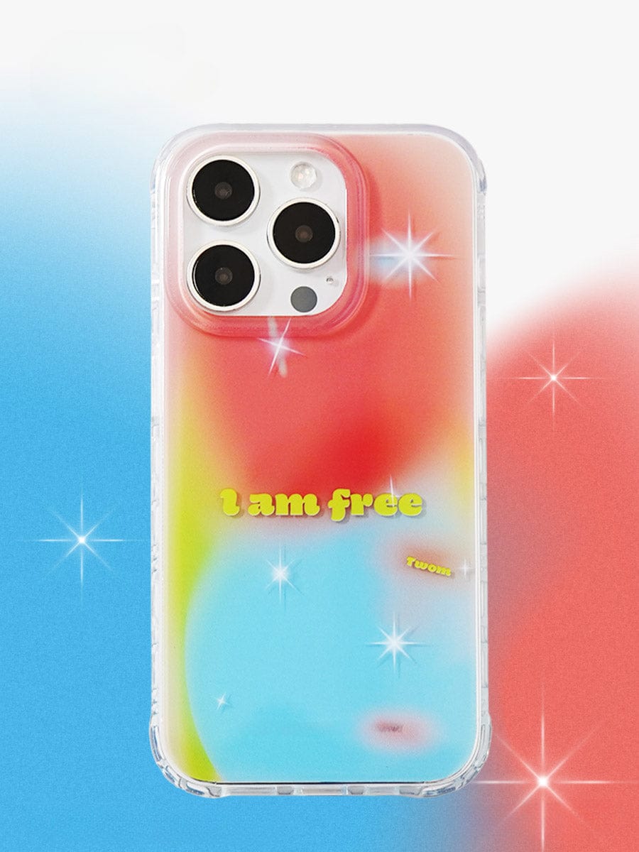 Displayed is the "I Am Free Gradient iPhone 16 Pro Max Case", featuring a vibrant multicolored design with shades of red, yellow, green, and blue enhanced by sparkles. The case showcases the phrase "I am free" in yellow text at the center, accompanied by a small inscription "twzz" on the side. This reflective, all-inclusive protective cover combines style and functionality for your device.