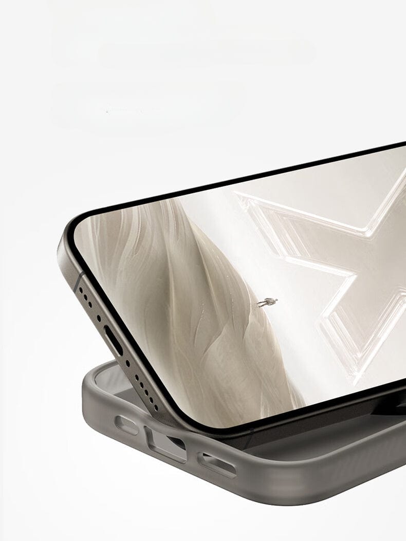 A close-up of an iPhone 16 Pro Max encased in a gray Hdens matte finish shockproof cover, displaying the screen image of a person climbing a steep, white rock formation.