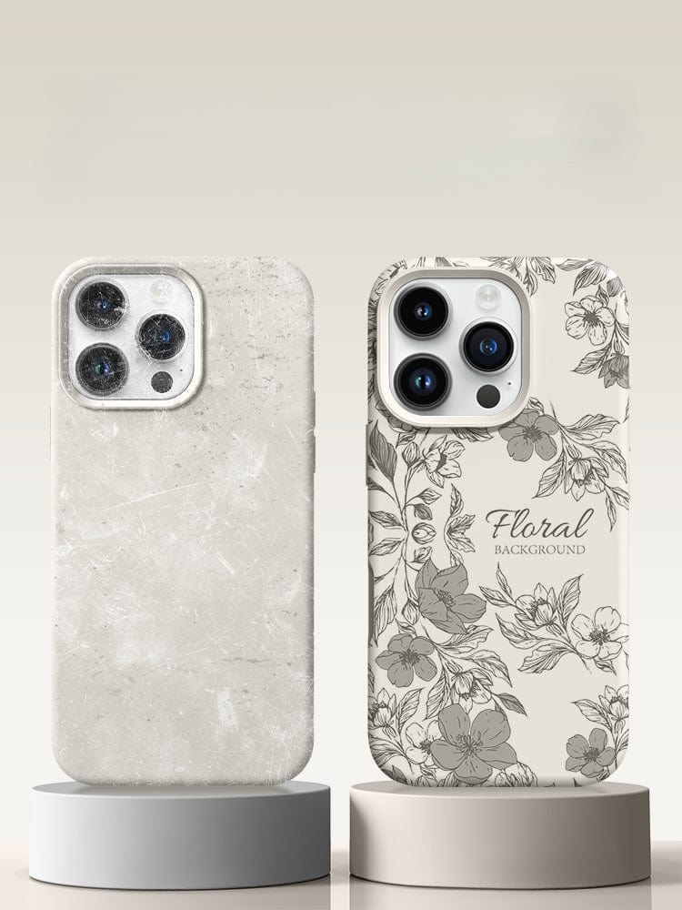 Two smartphones with different cases stand on individual pedestals. The left phone has a marbled case, while the right features an iPhone 16 Pro Max Case - Floral Silicone Protective Cover with a shockproof triple-layer design and an anti-fingerprint coating, offering 360° protection. Both cases guard the back and sides of the phones seamlessly.