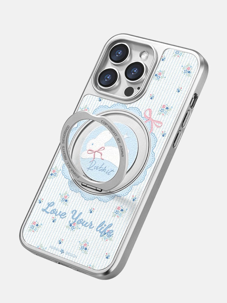 This Cute iPhone 16 Pro Max Case, featuring a floral pattern with the "Love Your Life" text and a 蓝色碎花小兔 motif, comes with a built-in magnetic stand and SGS-certified drop protection for added convenience.