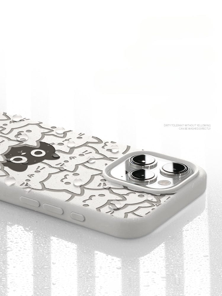 The iPhone 16 Pro Max Cute Cat Pattern Case, featuring a delightful design of black and white cartoon cats on a white background, is presented from the back and side angles with visible water droplets on its surface. Made from premium liquid silicone material, this case provides triple-layer shockproof protection and ensures durability with its anti-dust and washable properties.