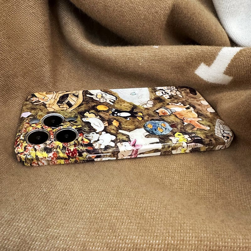 The Charming Woodland Animals iPhone 16 Pro Max Case, featuring a whimsical nature scene with various cartoon animals, is showcased beautifully on a brown fabric backdrop.