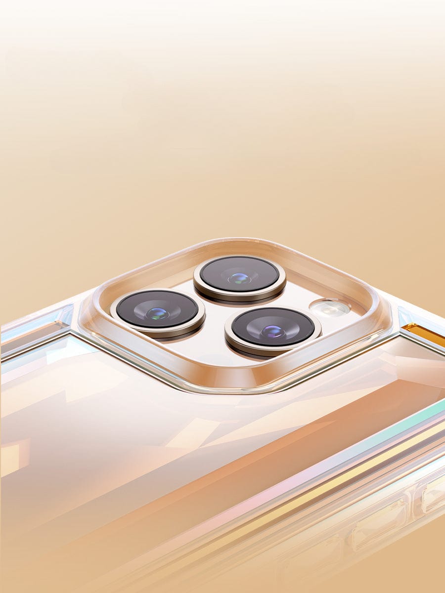 Close-up of a modern smartphone's three-lens rear camera module featuring an iPhone 16 Pro Max Case - Shockproof 360° Clear Anti-Fall Protective Cover with a 3D Gem Design in a golden metallic frame on a light golden background.