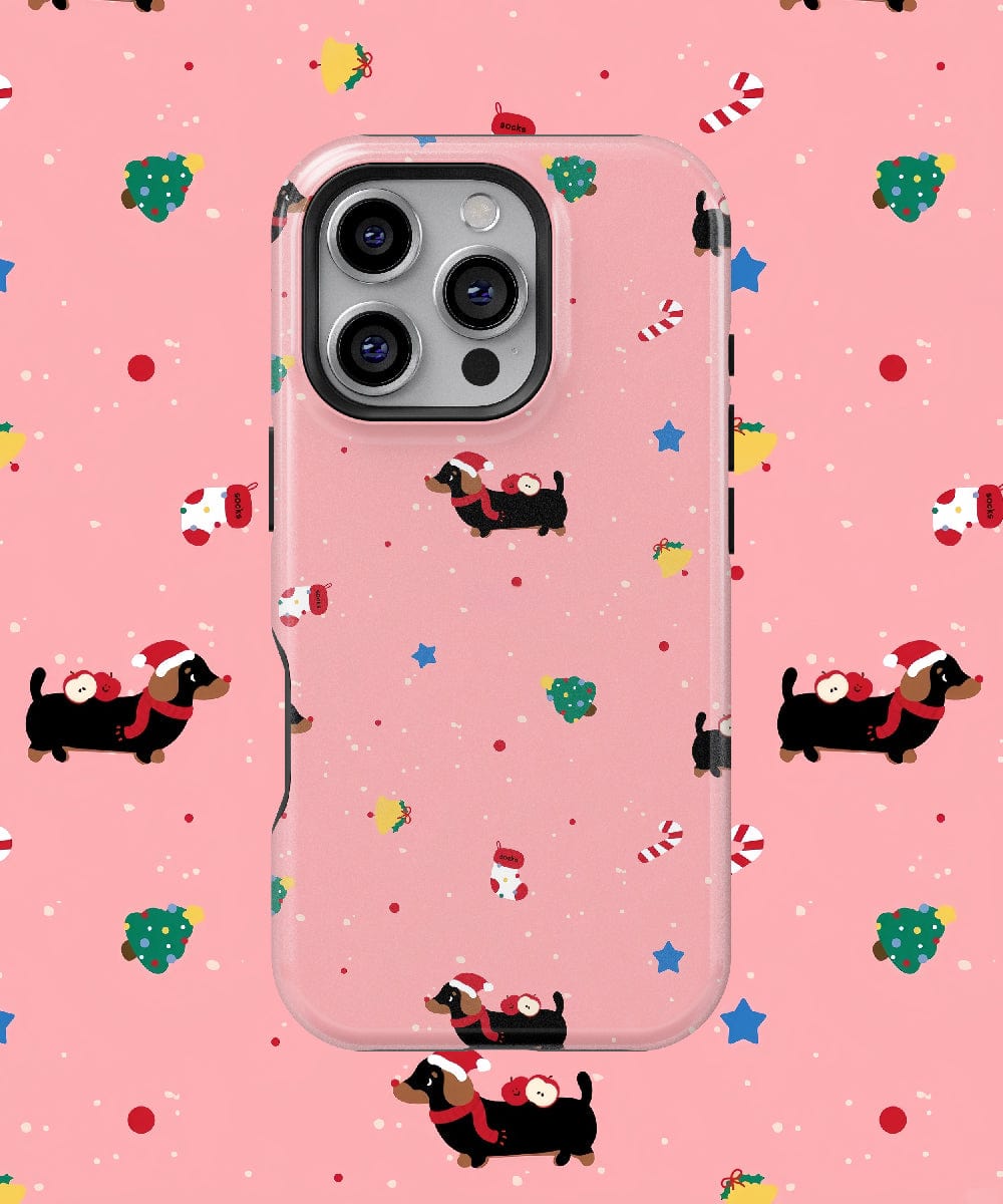 Introducing the Festive Dog Design Christmas Dachshund iPhone 16 Pro Max Case, showcasing adorable dachshunds in Santa hats against a festive pink backdrop. Benefit from its durable dual-layer protection and MagSafe compatibility, ensuring your phone is stylish and secure for the holiday season.