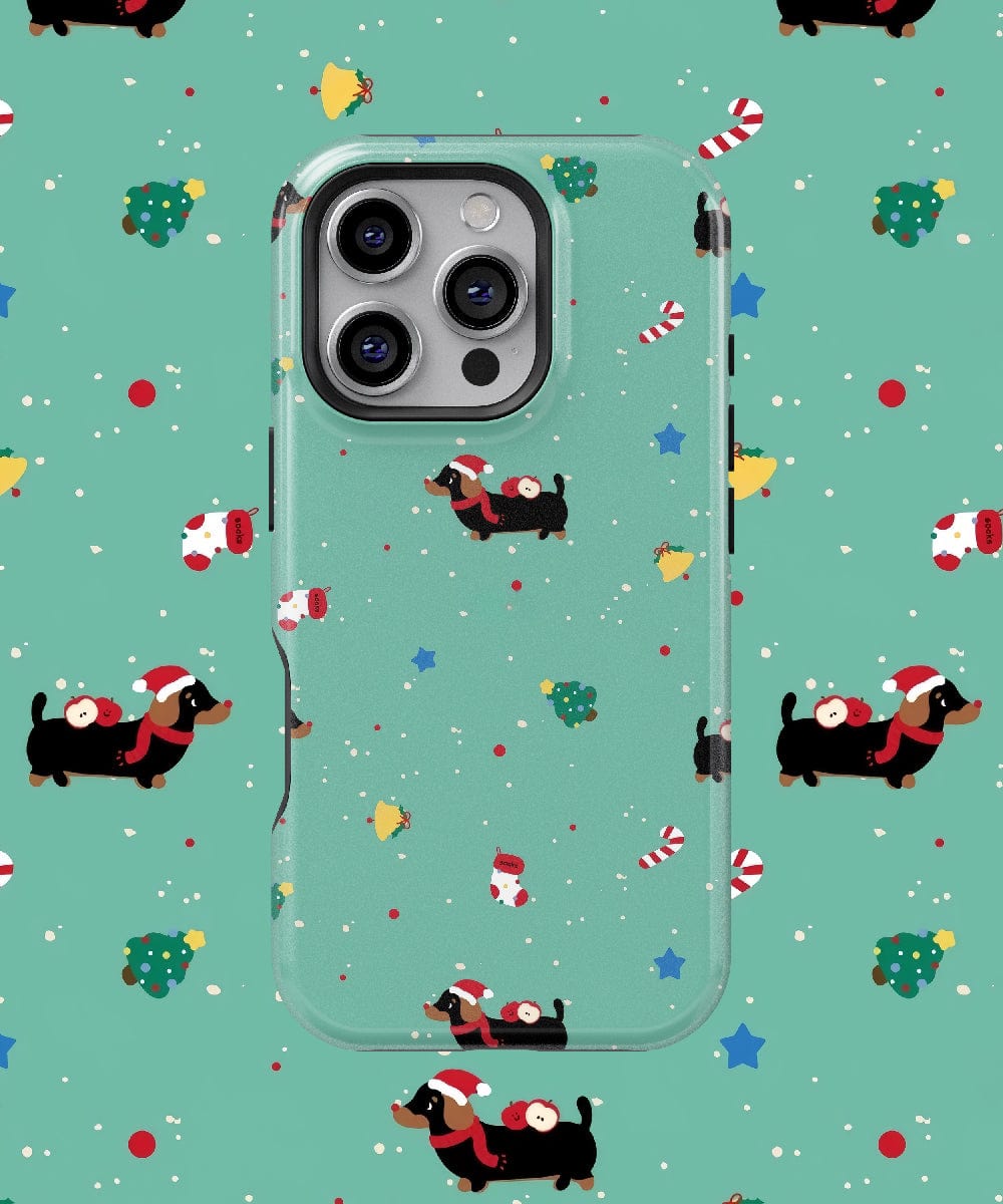 The Christmas Dachshund iPhone 16 Pro Max Case—featuring a cute holiday pattern of black dachshunds in Santa hats, candy canes, and Christmas trees—provides MagSafe compatibility and durable dual-layer protection to keep your phone safe and stylish during the holiday season.