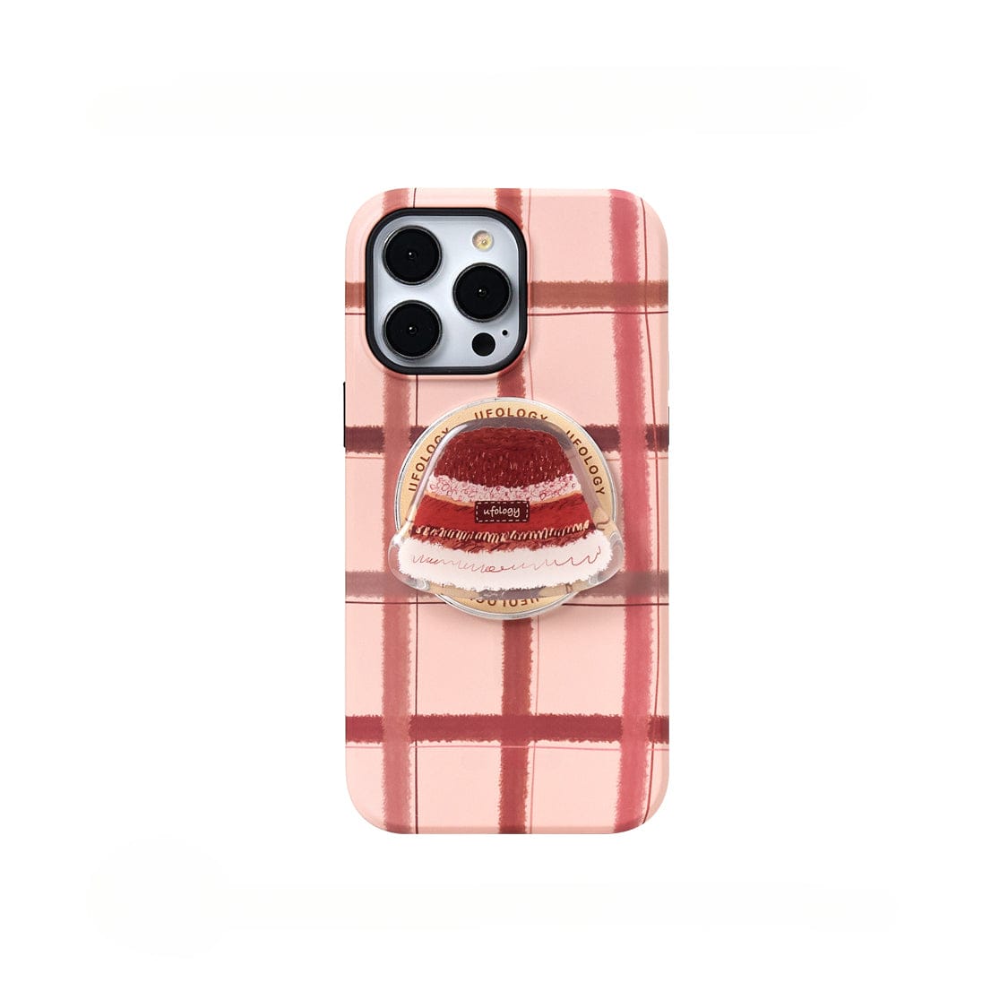 A smartphone in a Cozy Plaid MagSafe iPhone 16 Pro Max Case, featuring a warm winter hat design and an all-inclusive protective cover, complete with a circular grip accessory showcasing a red and white cake design, is shown against a white background.