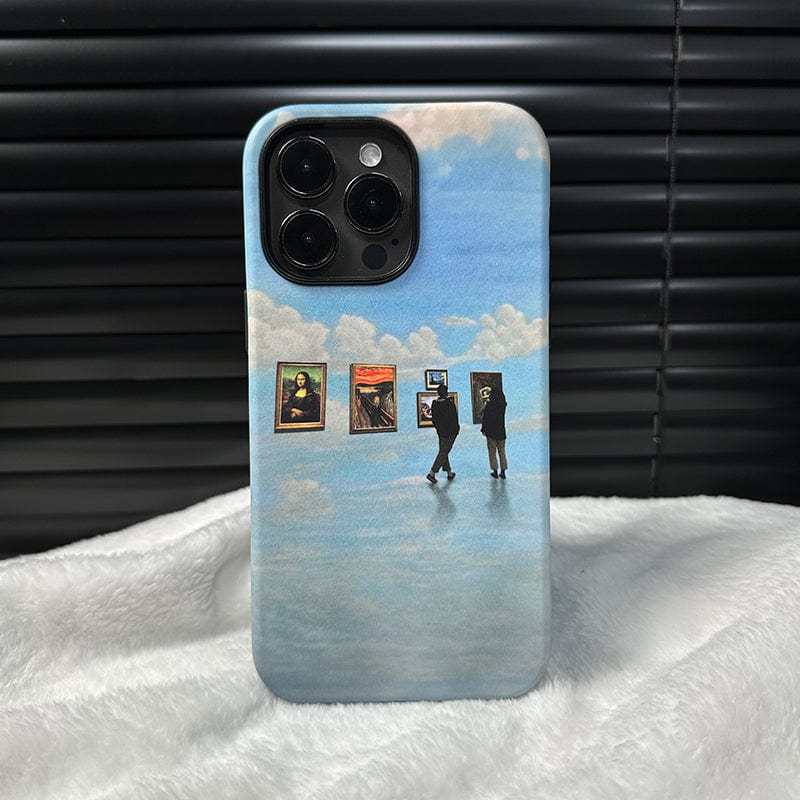 A Surreal Art Gallery iPhone 16 Pro Max Case - Dreamy and Protective, featuring an artistic design, sits on a white fabric surface. The case displays a surreal scene of two figures viewing paintings floating in mid-air against a backdrop of clouds. The background behind the phone is a dark, ridged surface.