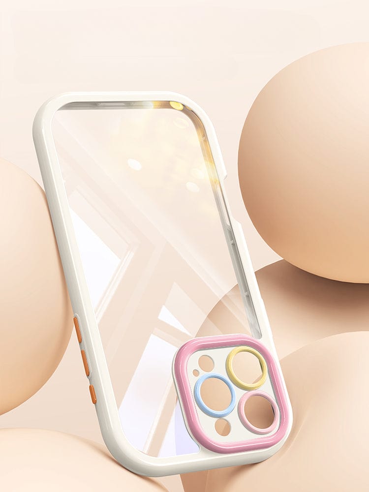 The iPhone 16 Pro Max Clear Case, a transparent silicone protective cover with a white border and colorful camera ring, is shown against a beige background adorned with round, smooth objects. This durable shockproof accessory provides anti-yellowing and scratch-resistant features for long-lasting clarity and defense.