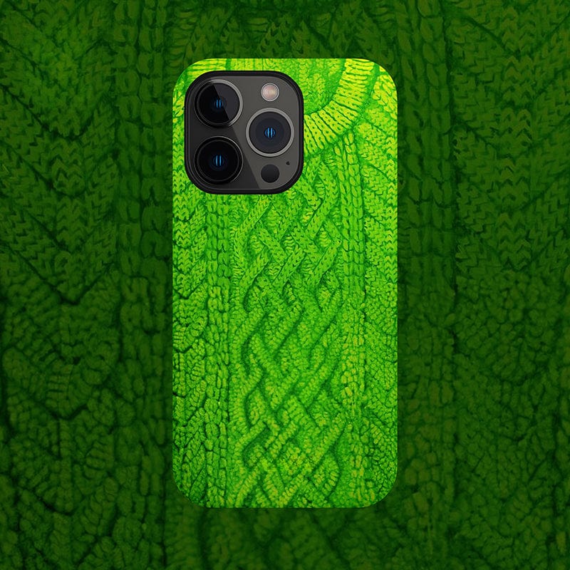 A Cozy Knitted Sweater iPhone 16 Pro Max Case in a vibrant green, featuring an intricate cable knit pattern. The texture mimics a cozy, detailed knit design, with the camera lenses peeking out from the top left corner of the case.