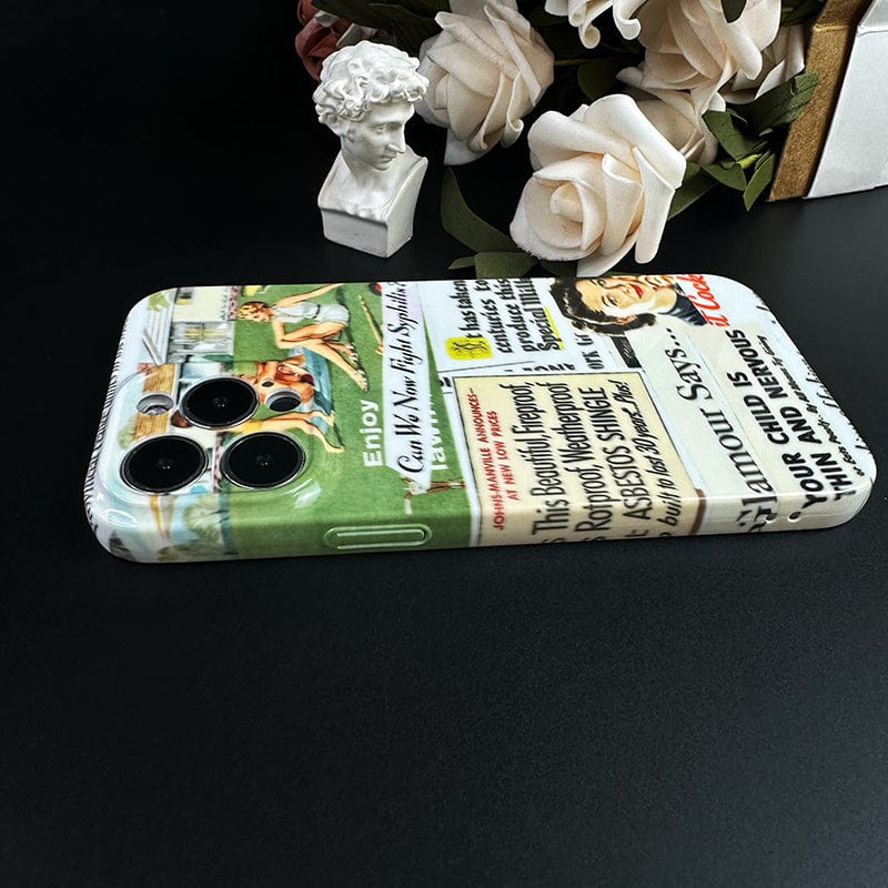 A smartphone adorned with the Vintage Advertisement Collage iPhone 16 Pro Max Case - Retro Pop Art Design with Full Protection lies on a black surface. Beside it, there is a small white bust sculpture and a bouquet of white roses in the background.