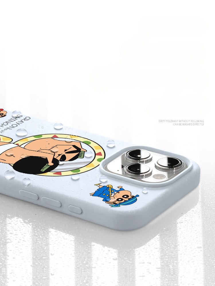 The iPhone 16 Pro Max Crayon Shinchan Case - Cute Cartoon Design, made from premium liquid silicone material with triple-layer shockproof protection and a soft touch, showcases light-colored cartoon characters and water droplets on its surface in an overhead angle photograph.