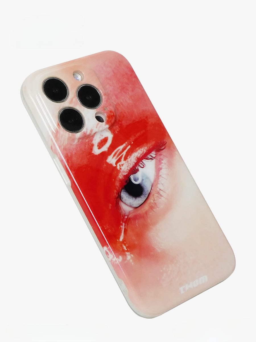 The Red Eye Art iPhone 16 Pro Max Case | Bold Artistic Expression | All-Inclusive Protective Cover features a close-up image of a red eye on its back. Predominantly white except for the eye design, the case delivers a striking and artistic appearance.