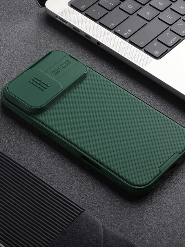 An iPhone 16 Pro Max Camera Slider Case with dual-layer protection, a textured design, and anti-scratch and shockproof features is placed next to a laptop keyboard on a dark surface.