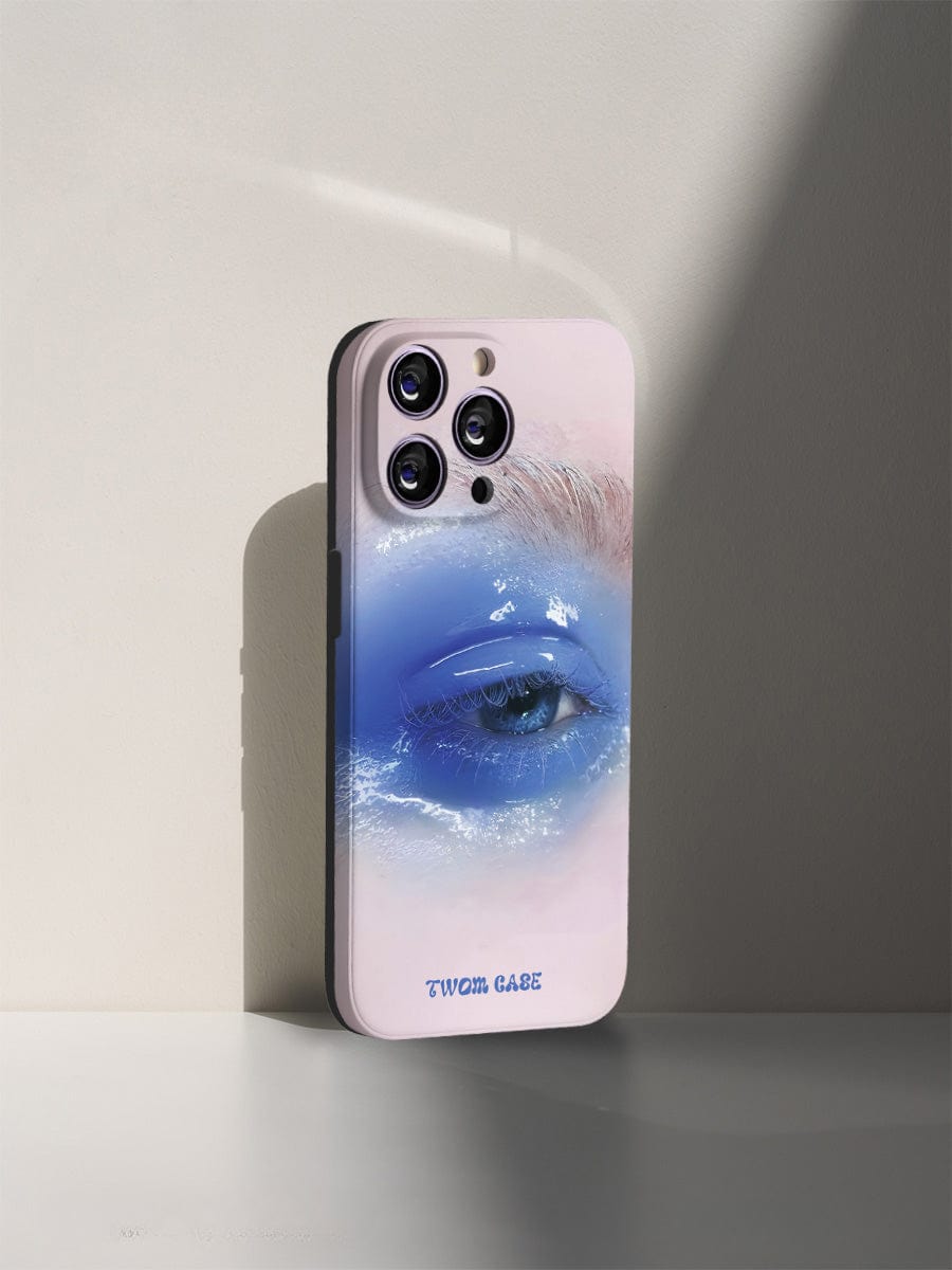 A Dreamy Blue Eye iPhone 16 Pro Max Case features a surreal and elegant close-up image of a blue eye with white eyelashes. The realistic and detailed artwork captures the eye's reflective surface, and the text "TWOEM CASE" is printed at the bottom of the all-inclusive protective cover.