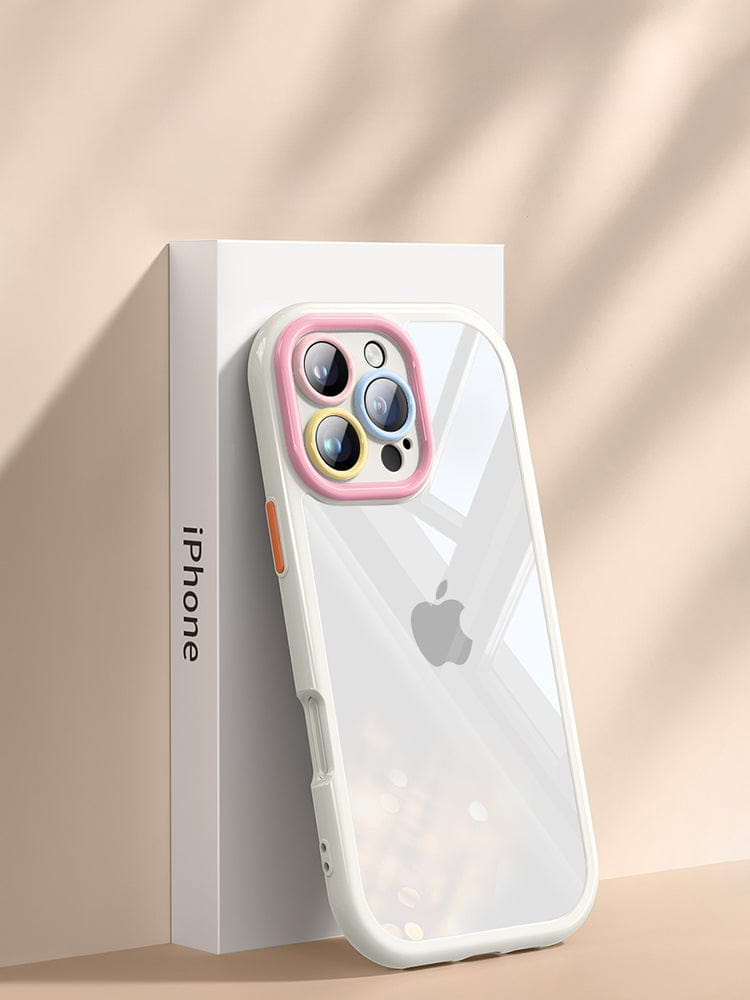 A white iPhone in the transparent, anti-yellowing, shockproof, and slim-fit iPhone 16 Pro Max Clear Case stands upright against its packaging box. The three camera lenses are accented by a colorful ring on the back of the phone, emphasizing its elegant design. Shadows fall diagonally across the background.