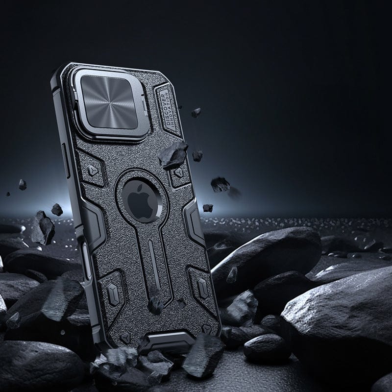 Placed upright on a dark, rocky surface, the Rugged MagSafe iPhone 16 Pro Max Case showcases its durable and protective features with a reinforced design. It boasts a shockproof TPU + PC + metal construction and includes a hinged camera shield for added security.