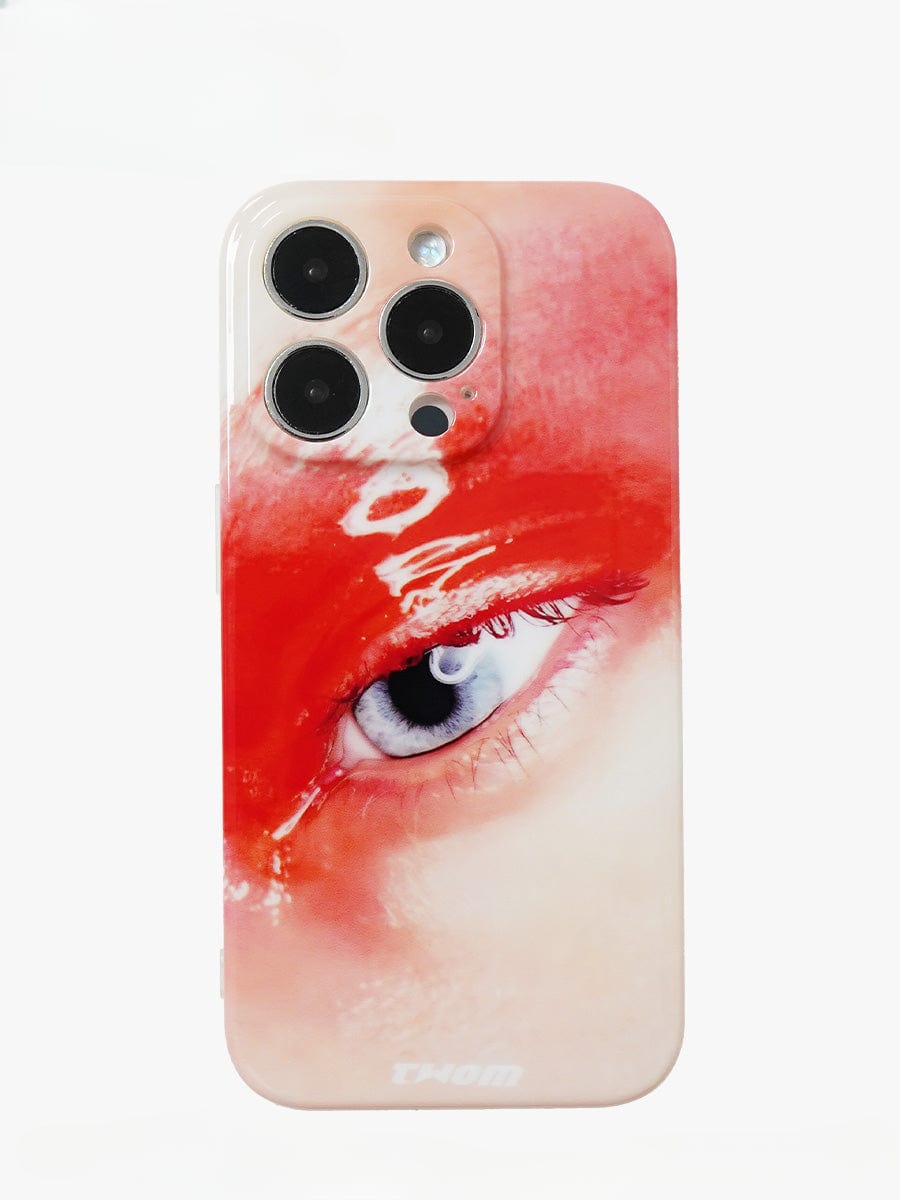 The Red Eye Art iPhone 16 Pro Max Case features a close-up image of a blue human eye, surrounded by red makeup or paint. This strikingly detailed design creates a dramatic and artistic effect, making it both an all-inclusive protective cover and a bold statement piece.