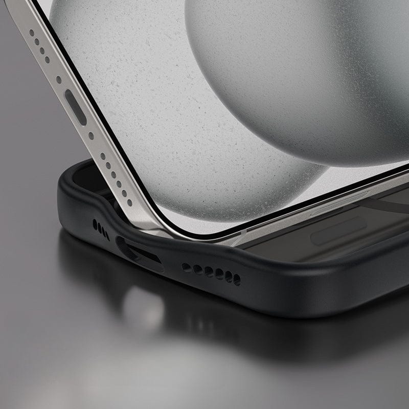 A close-up of the iPhone 16 Pro Max, encased in a Golden Shield MagSafe Case. The phone's screen and edge are clearly visible, resting on a reflective surface that highlights its sleek design and MagSafe compatibility. The black protective case offers anti-fingerprint and shockproof protection, with an aluminum alloy camera frame.