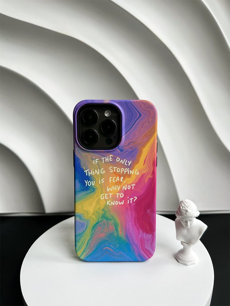 The Inspirational Swirl iPhone 16 Pro Max Case, featuring a colorful abstract design and the motivational quote "IF THE ONLY THING STOPPING YOU IS FEAR WHY NOT GET TO KNOW IT?", rests on a round white platform. Beside the phone case, a small white bust sculpture of a historical figure adds an elegant touch.