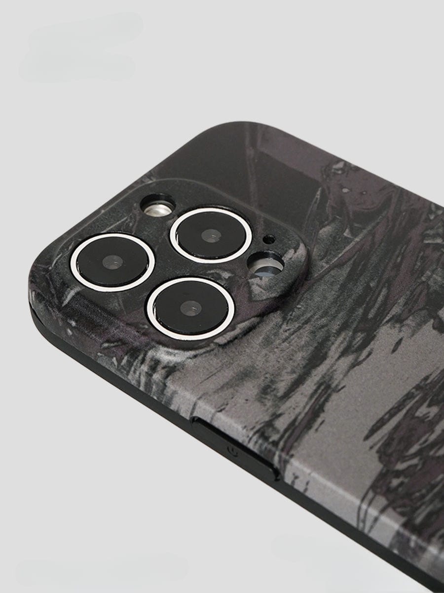 Close-up of a smartphone equipped with the Monochrome Marble iPhone 16 Pro Max Case, featuring an abstract artistic design in black and gray textures, clearly displaying three camera lenses and a flash on the back.