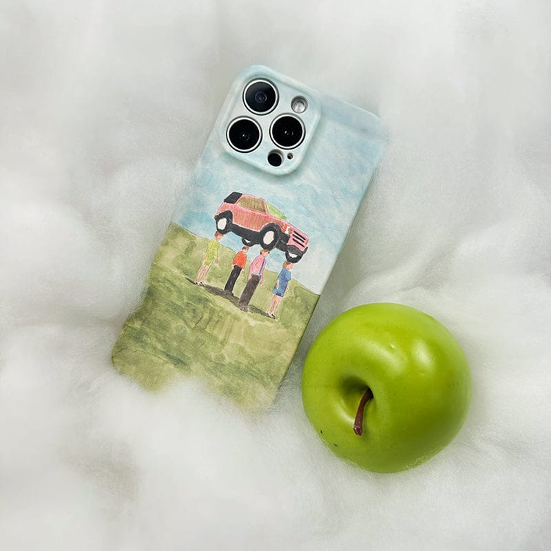 An iPhone 16 Pro Max case from the "Surreal Car Lift" series, showcasing whimsical watercolor art of five people lifting a vehicle above their heads, lies on a fluffy white surface. Next to the phone is a green apple with a small brown spot near the stem.