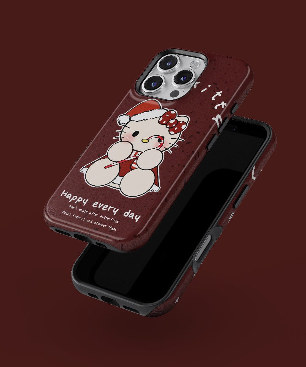 The Christmas Lucky Kitty iPhone 16 Pro Max Case showcases a festive cute cat design, adorned with a red bow and winter outfit. The text on the case reads "happy every day." It is MagSafe-compatible and features a dark brown color beautifully set against a matching brown background.