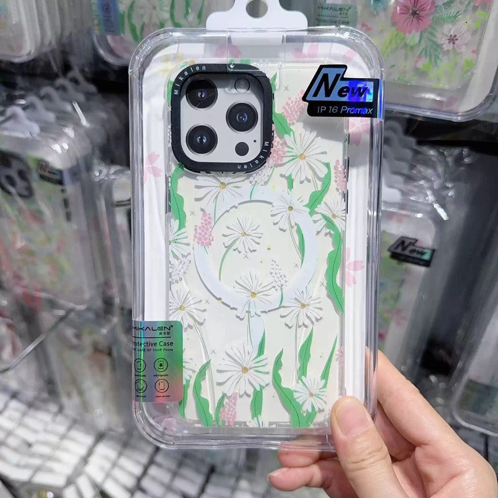 A person holds a package containing the Floral MagSafe iPhone 16 Pro Max Case, featuring a shockproof clear cover with a 3D flower design and green trim, specifically designed for multi-lens camera smartphones.