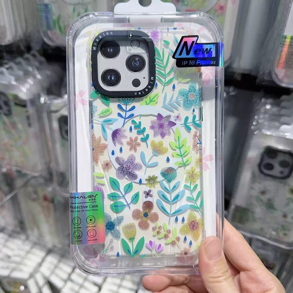 A hand holds a vibrant iPhone 16 Pro Max case featuring a colorful flower pattern. The label reads "Floral MagSafe iPhone 16 Pro Max Case," highlighting its shockproof protection and compatibility with MagSafe technology.