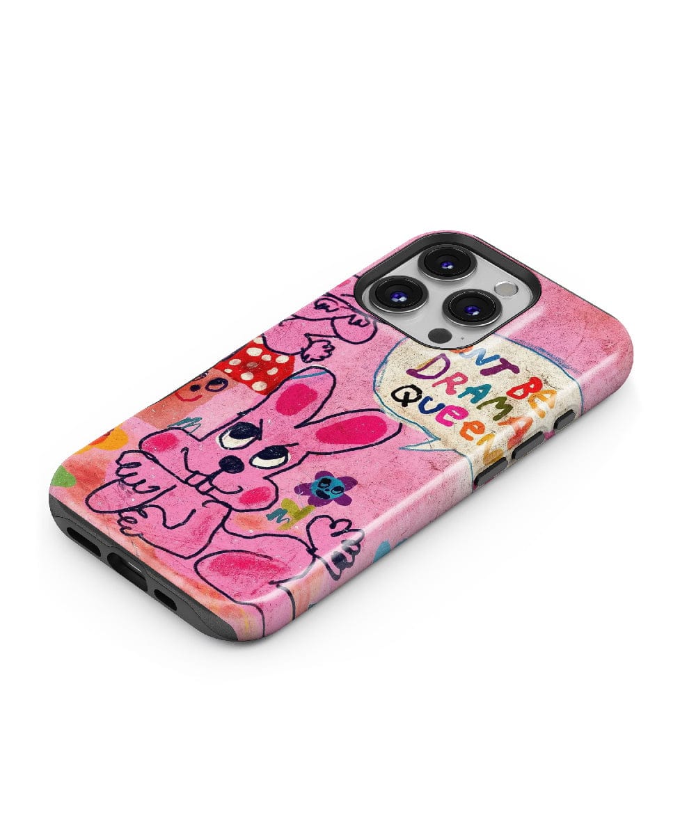 A smartphone with a shockproof Pink Bunny "Don’t Be a Drama Queen" iPhone 16 Pro Max case, featuring quirky cartoon characters, bold colors, and a fun aesthetic.