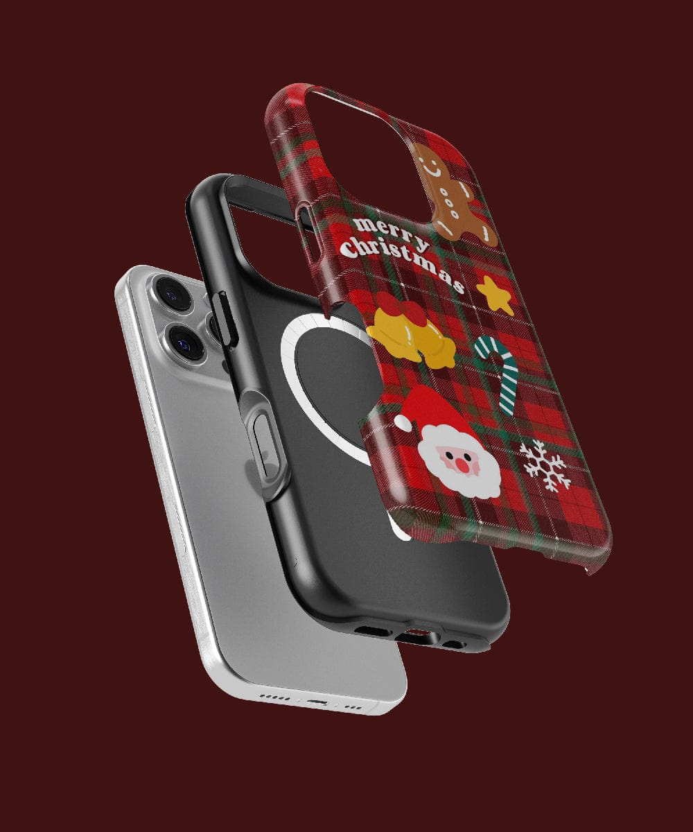 Three phone cases levitate above: a sleek, white one; a black one adorned with a heart; and the Plaid Christmas iPhone 16 Pro Max Case, with its classic holiday design featuring festive icons. It's MagSafe compatible and offers dual-layer protection to ensure peace of mind during every holiday celebration.