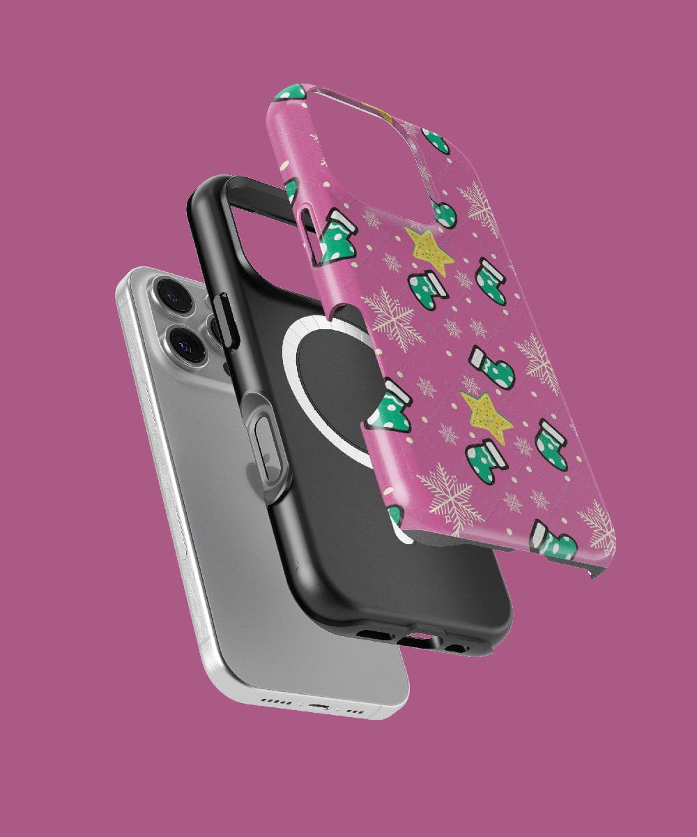 Three MagSafe-compatible smartphone cases are suspended in mid-air: a sleek silver, a black with a grip, and the Festive Stocking iPhone 16 Pro Max Case – Pink Holiday Design, featuring snowflakes and stars—an ideal festive stocking stuffer. Each case is stylishly highlighted against a vibrant purple background.