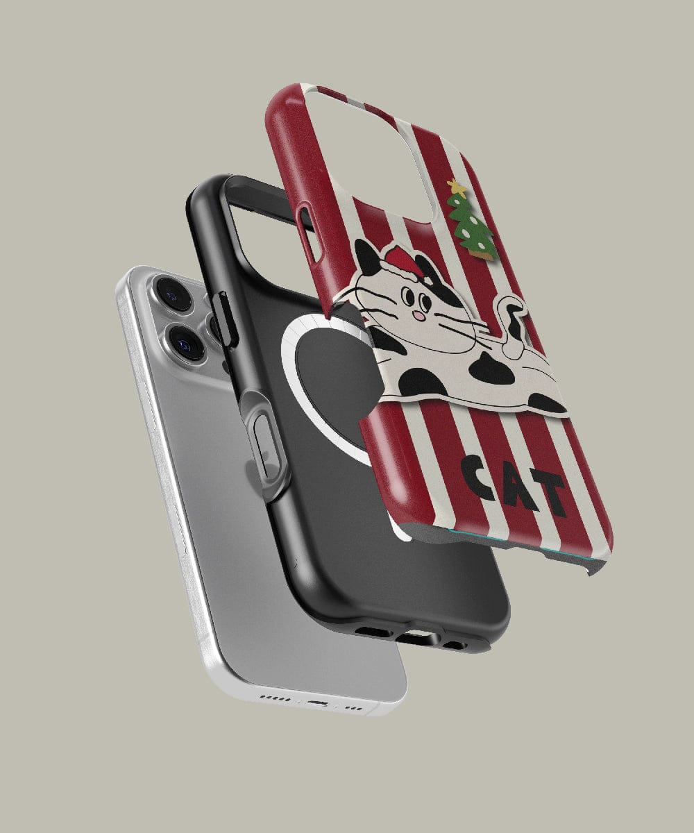 Three smartphone cases soar in mid-air: a silver one, a MagSafe-compatible black case featuring a white teacup design, and the Festive Striped Cat iPhone 16 Pro Max Case with playful holiday cat design, red stripes, and MagSafe compatibility.