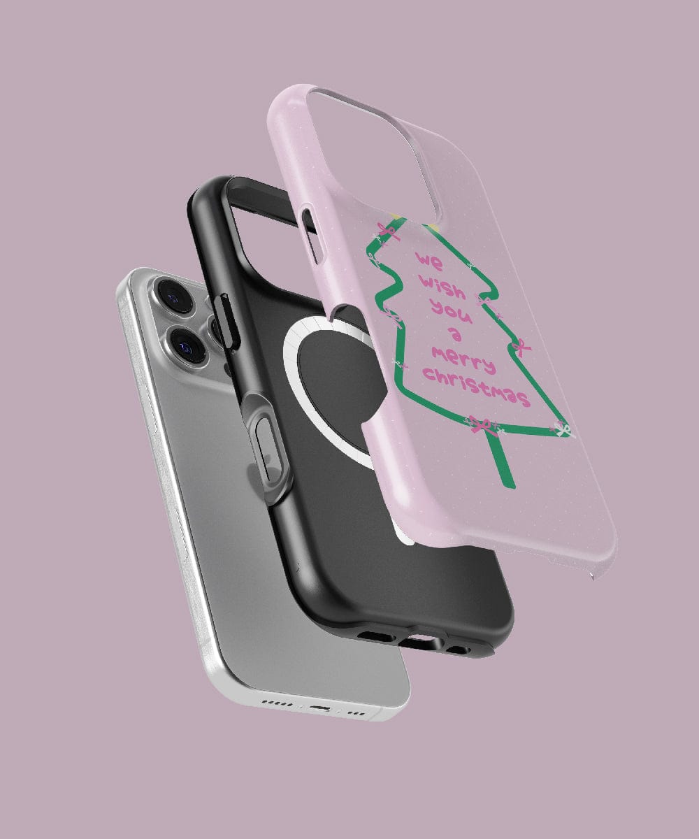 Displayed are three iPhone 16 Pro Max cases: a MagSafe-compatible silver case, a black dual-layer protection case with a circular cutout, and the Merry Christmas Tree iPhone 16 Pro Max Case in festive pink featuring a holiday design with the words "we wish you a merry Christmas.