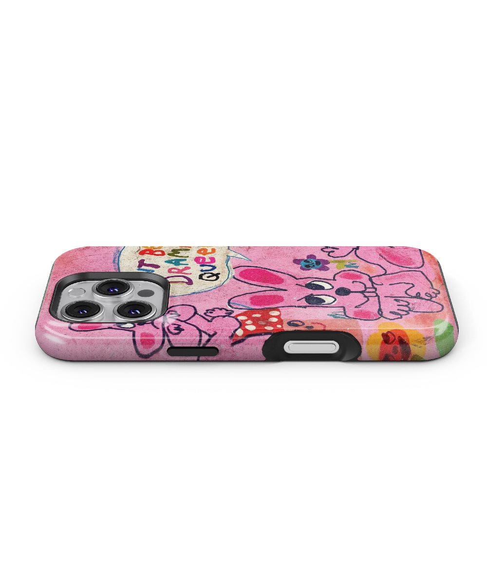 The Pink Bunny "Don’t Be a Drama Queen" iPhone 16 Pro Max Case features a quirky cartoon design with bold colors and various colorful elements like hearts and flowers. The case showcases a smiling bunny alongside the text "Good Vibes," offers shockproof protection, and is perfectly fitted for an iPhone 16 Pro Max with three visible cameras.