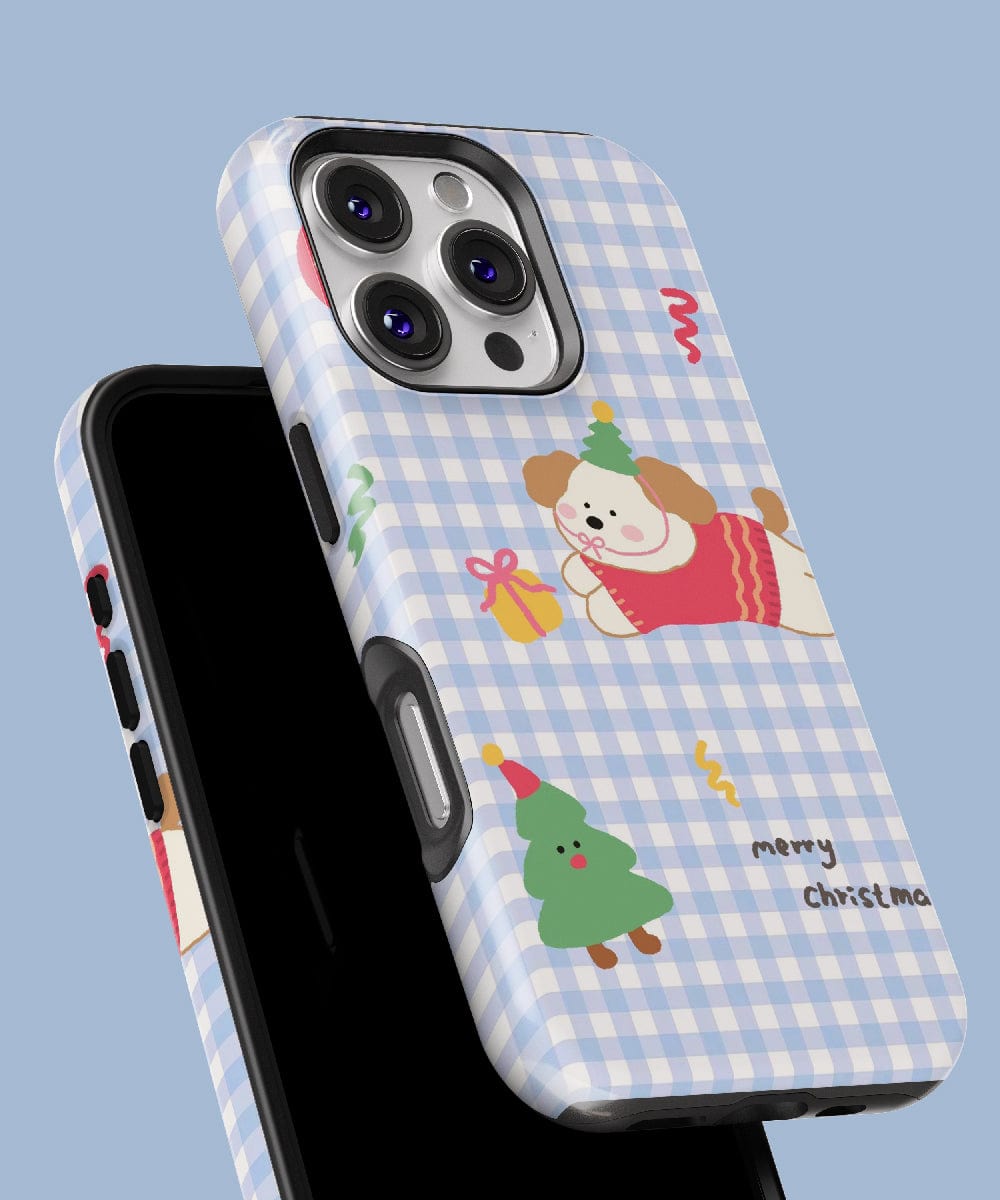 The Gingham Christmas Puppy iPhone 16 Pro Max Case features a delightful holiday design with charming illustrations of a dog, presents, and a tree on a blue checkered pattern, all while being MagSafe compatible.